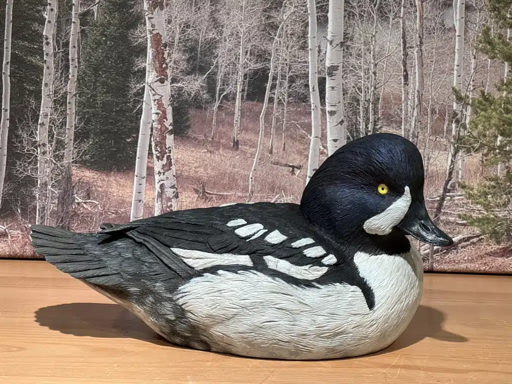 Hand-painted wooden duck decoy on table